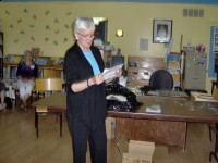 Carol reading one of the letters in the Time Capsule